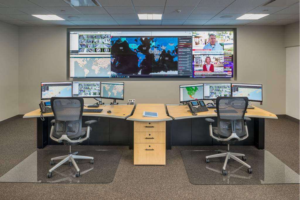 A Government Security Operations Center with a video wall and two consoles