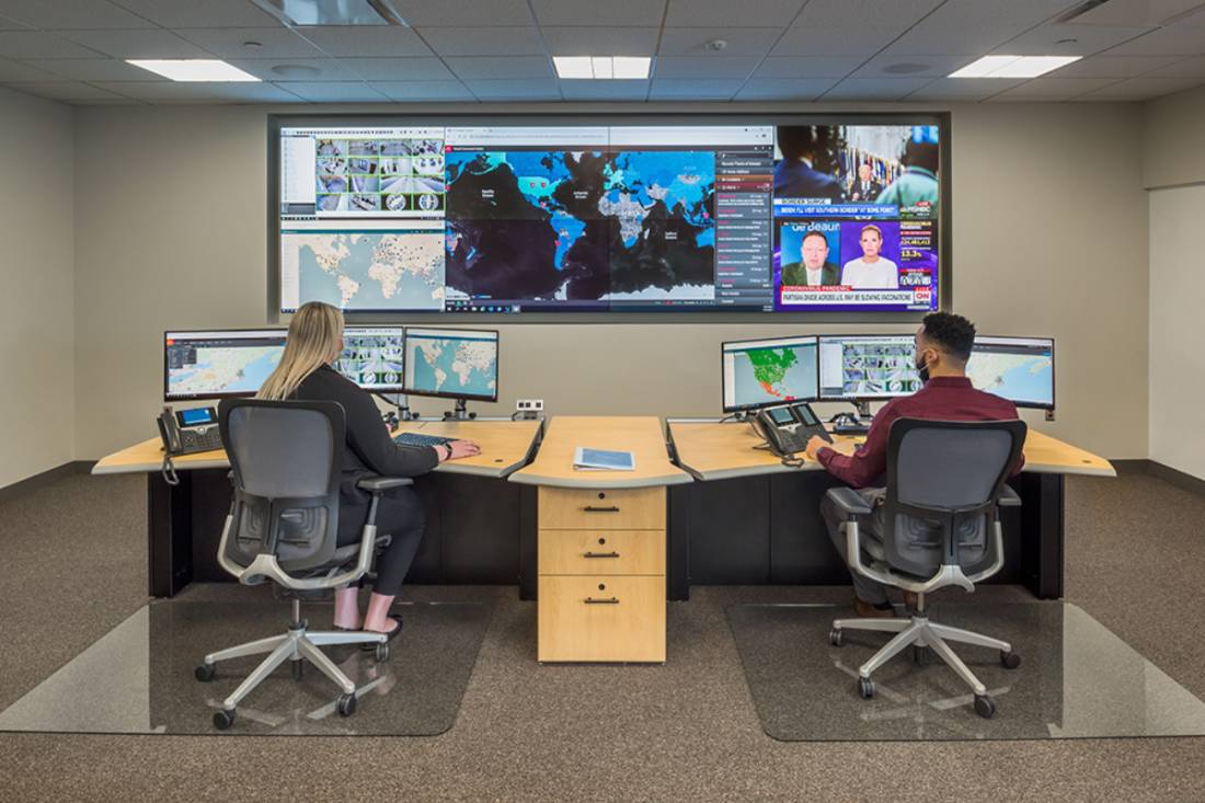 two operators sitting at desks in the GSOC