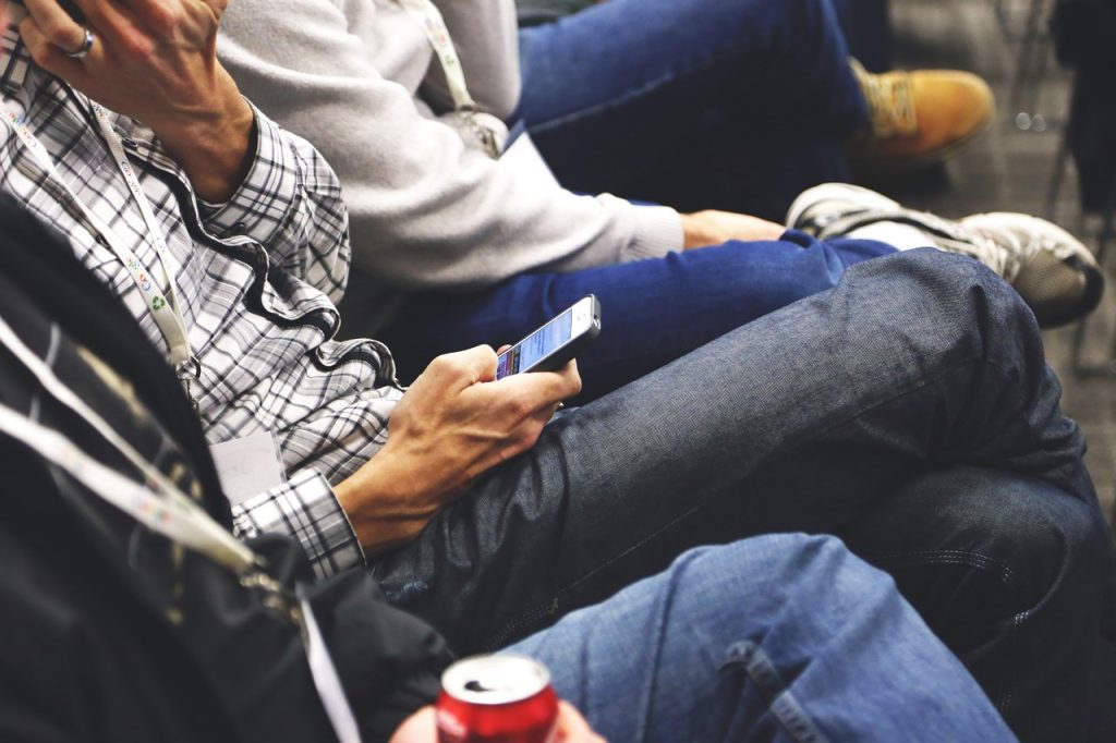 person on public transportation using smartphone