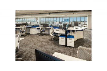 a cubicle in an office with a computer on it