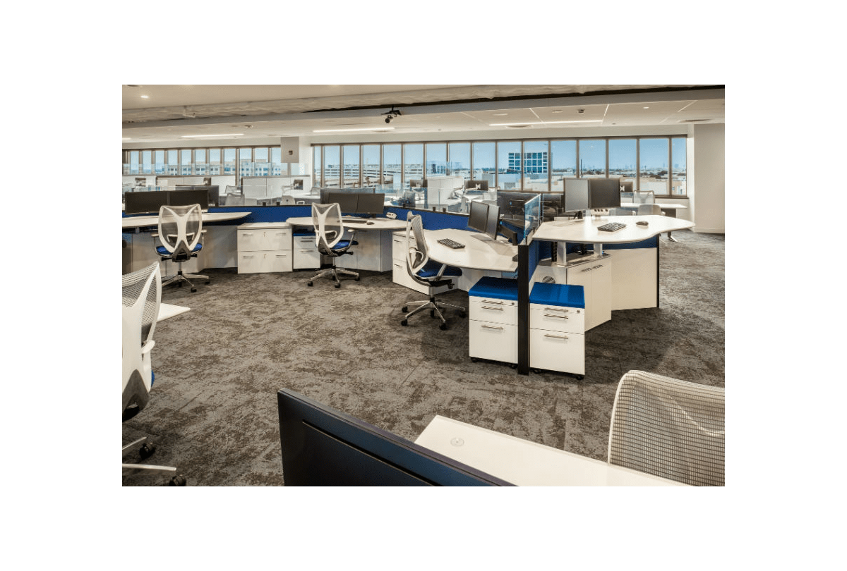 a cubicle in an office with a computer on it
